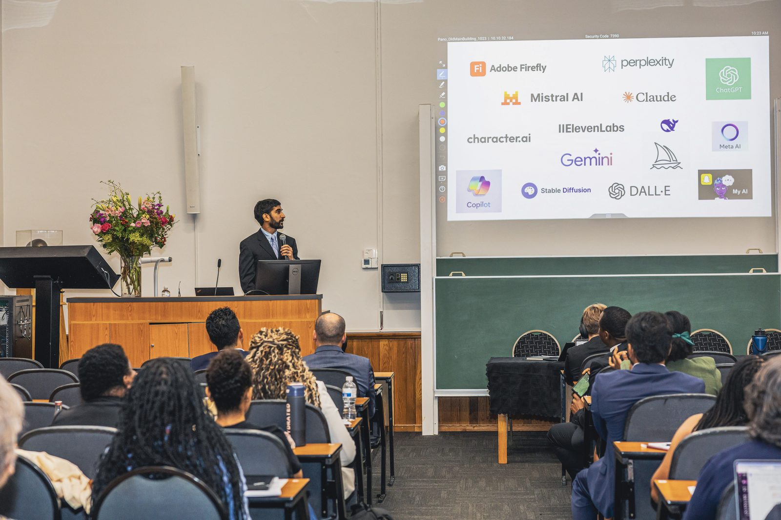 Sameer Hinduja delivering a keynote on generative AI and youth, with AI tools shown on screen